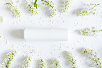 Flat lay. Soothing cream. Face cream with flowers extract. Closeup. White cosmetics concept on  white background with  flowers. Cosmetic and skin care concept. Copy space for your design.