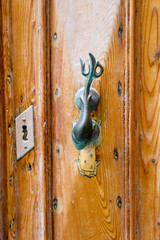 Vintage door fish handle on the old wooden door, Mosta, Malta