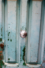 Rusty door handle on old wooden door of abandoned house, Valletta, Malta