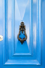old bright blue wooden door with vintage black iron handle, Mdina, Malta