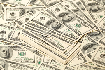 Canvas money sack with one hundred dollar bills 