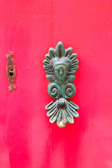 old vintage door handle on red wooden door closeup, Valletta, Malta