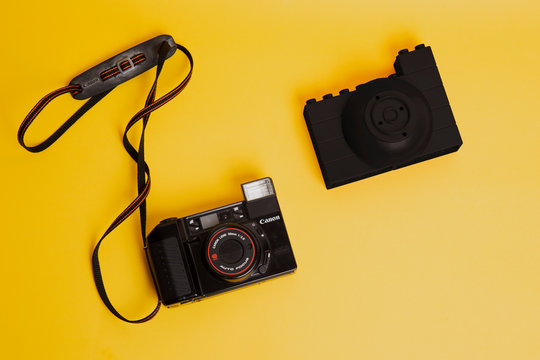 Canon vintage camera blocks plastic toy comparison on color background