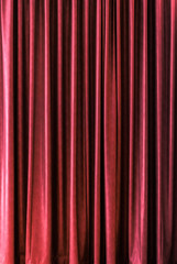 red closed stage curtain with light effect