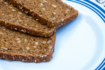 Sliced rye bread on cutting board closeup