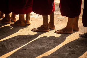 Buddhist monks feet in a line