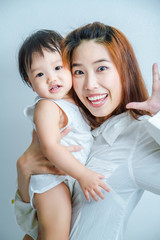 Family, Happy asian mother and baby daughter play in action
