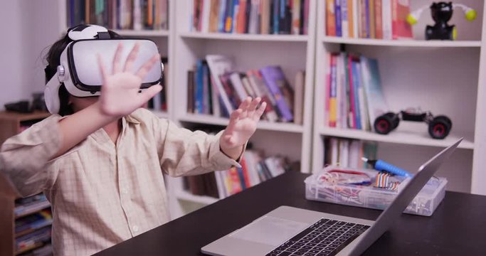 Little boy wearing vr with funny emotion  alone at school. Technology and Education concept.