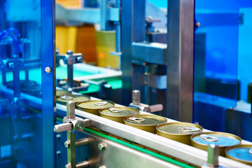 Canned food products on conveyor belt in distribution warehouse.parcels transportation system...