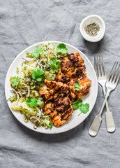 Delicious lunch - grilled chicken fillet and  dill, cilantro new potatoes salad on grey background, top view