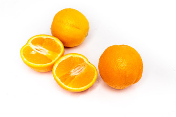 isolated on a white sprinkled water background, fresh, juicy orange fruits