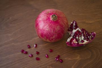 Ripe pomegranate on a wooden table background.