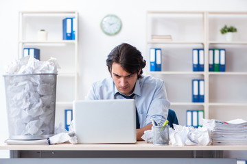 Businessman rejecting new ideas with lots of papers