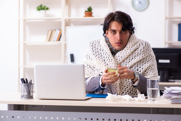 Man with flu working in the office