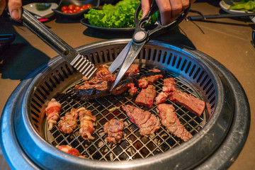 Closeup of Japanese style barbecue beef grilling on coal stove