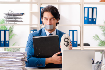 Young male employee with tape on the mouth 
