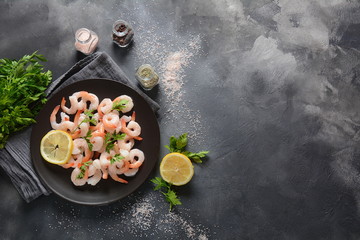 Fresh prawns. Raw shrimps, prawns in a plate on a dark background. Seafood
