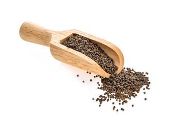 sesame seeds in wood scoop isolated on white background