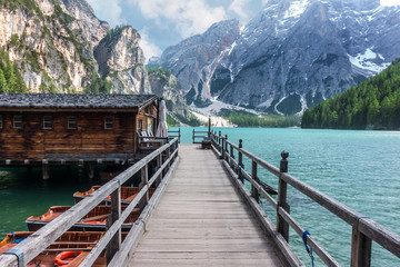 View from the jetty of Lake Braies with vivid colors in spring with mountains in the background