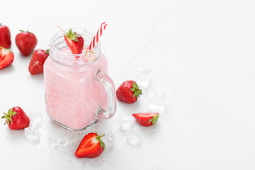 Strawberry smoothie or milkshake in mason jar .