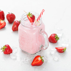 Strawberry smoothie or milkshake in mason jar .