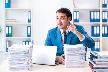 Young male employee unhappy with excessive work 