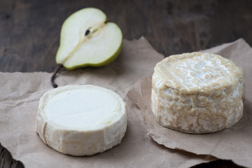 Piece smelly camembert cheese on a wooden rustic table