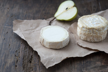 Piece smelly camembert cheese on a wooden rustic table