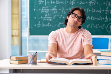 Young male student in the classroom 