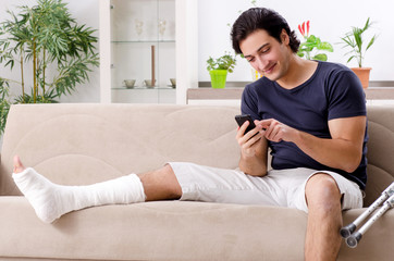 Leg injured young man suffering at home 
