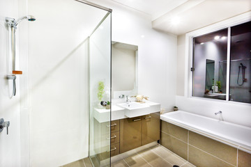 Fototapeta na wymiar Modern bathroom with a faucet, water tub and floor tiles