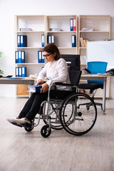 Female employee in wheel-chair at the office  