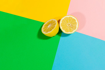A lemon is laying on a flat surface top view colored background food lemon