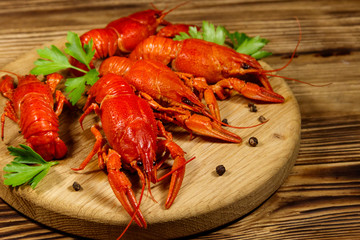 Boiled crayfish on cutting board on wooden table