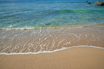 seascape with sand and wave bubble on the beach