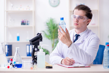 Young male chemist experimenting in lab