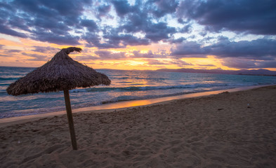Umbrella on beach. Sunset