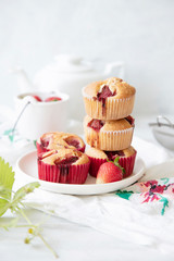 Freshly baked strawberry muffins on white background. Selective focus.