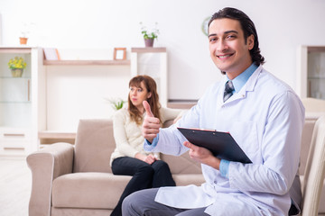 Young female patient discussing with male psychologist personal 