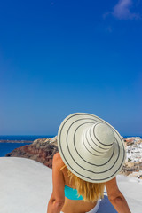 Fototapeta na wymiar Luxury travel vacation woman looking at view on Santorini island