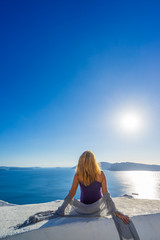 Luxury travel vacation woman looking at view on Santorini island