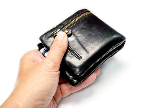 Closeup hand of human holding a black men's leather wallet isolate on white background and make with paths.