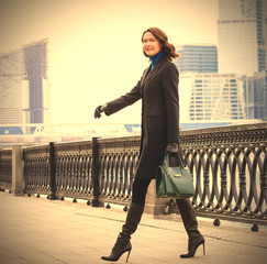 smiling pretty middle-aged woman in a fashionable dark coat