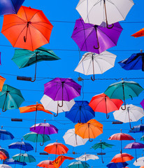 Fototapeta na wymiar hanging umbrellas against the blue sky, walk through the streets of Kaleici, Antalya