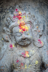Close up buddhist statue Kathmandu Nepal. Close up of oblations of food and flowers to their gods on small statues , Kathmandu, Nepal, Asia.