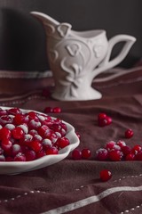 pomegranate on the table, frozen cranberries 