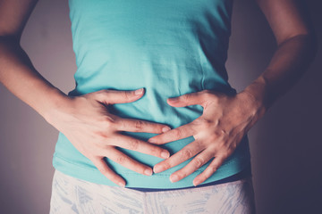 woman hands on her stomach, probiotics food for gut health, leaky guy, colorectal cancer concept