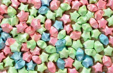 colorful star paper arraigning on wooden board