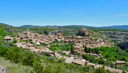 Panoramic view from above on the houses of medieval village Alquezar at daytime. Part of the Sierra de Guara Natural Park. Comarca Somontano de Barbastro, Huesca province, Aragon region, Spain.   