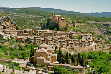 Panoramic view from above on the houses of medieval village Alquezar at daytime. Part of the Sierra de Guara Natural Park. Comarca Somontano de Barbastro, Huesca province, Aragon region, Spain.   